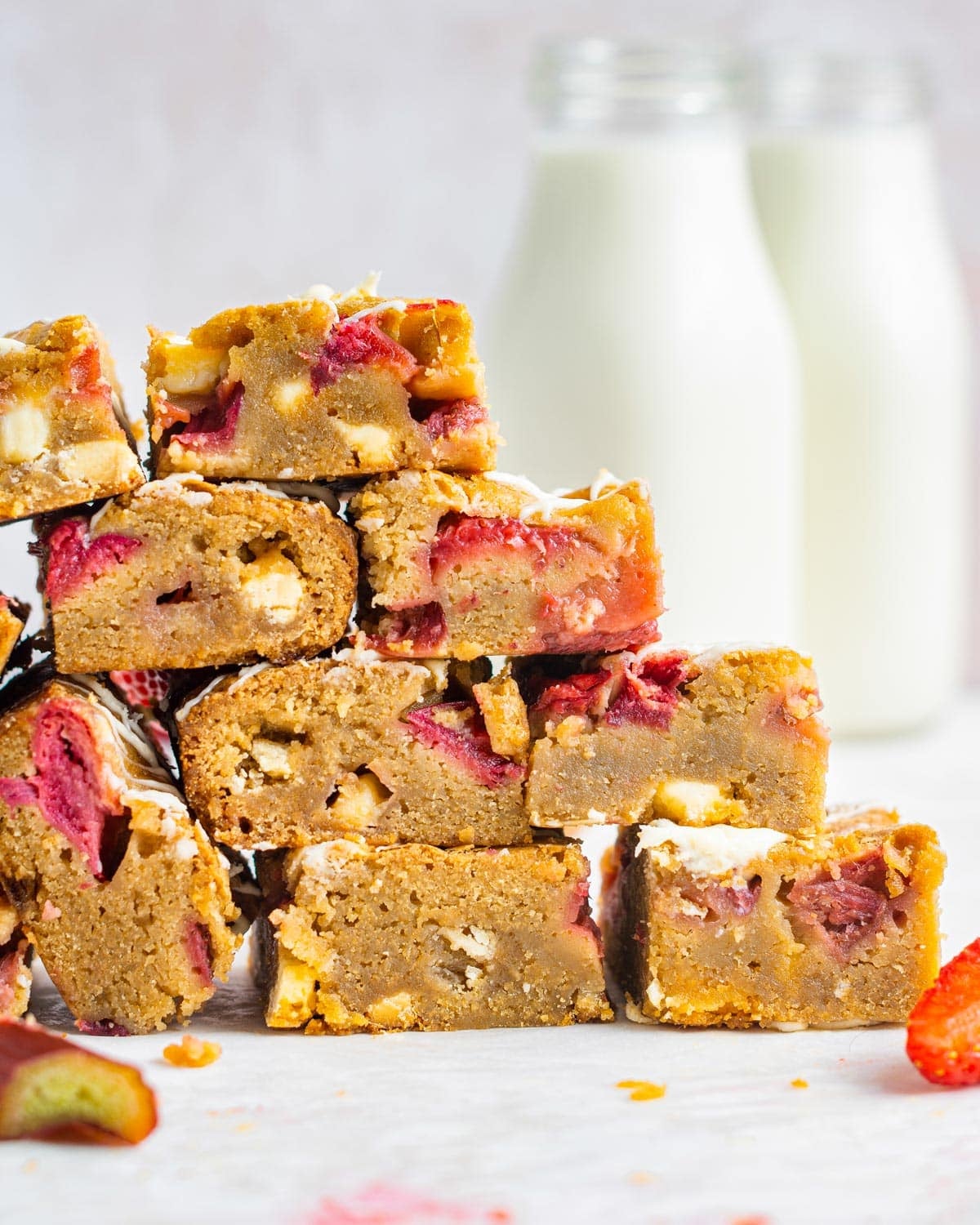 a stack of cookie bars with rhubarb and strawberries