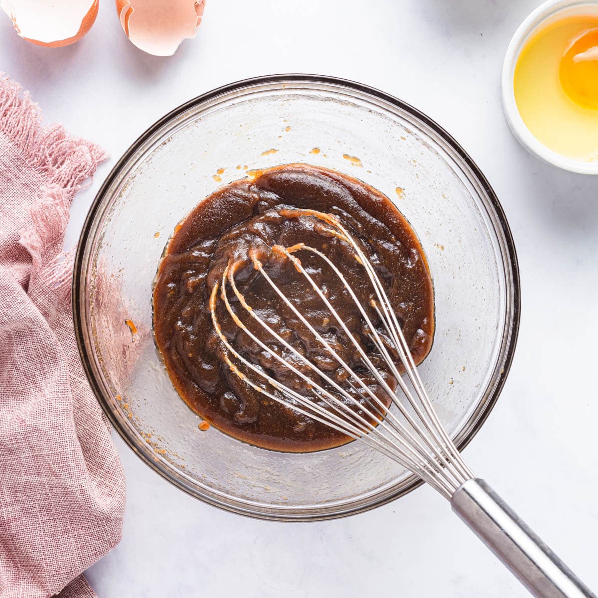 mixed butter and brown sugar in a bowl with a whisk