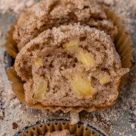 half of an apple cinnamon muffin on a baking pan