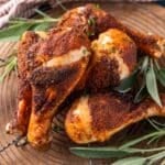 a pile of baked chicken wings with fresh herbs