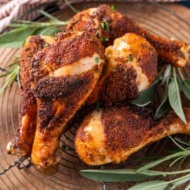 a pile of baked chicken wings with fresh herbs