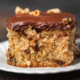 a piece of chocolate chip snack cake with frosting on a plate