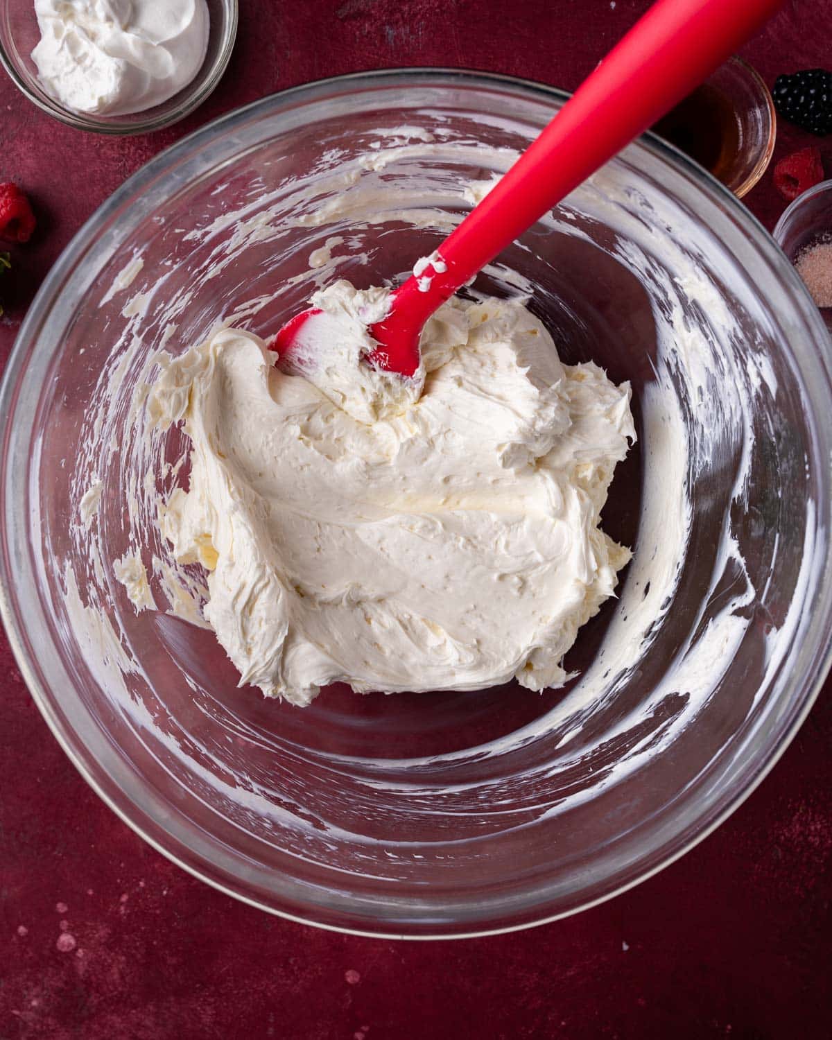 cream cheese and sugar mixed in a glass bowl