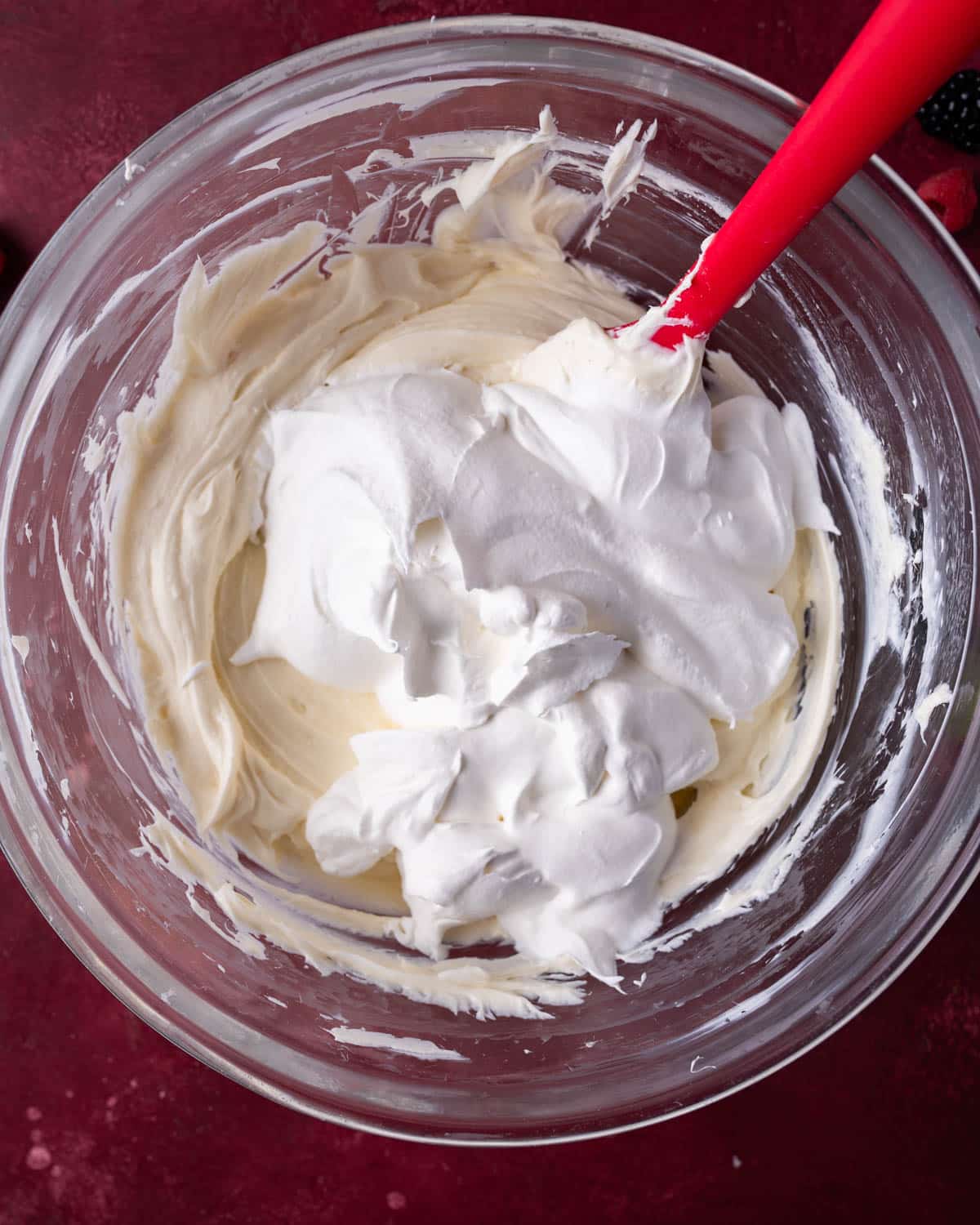 no bake cheesecake filing with whipped cream on top in a bowl