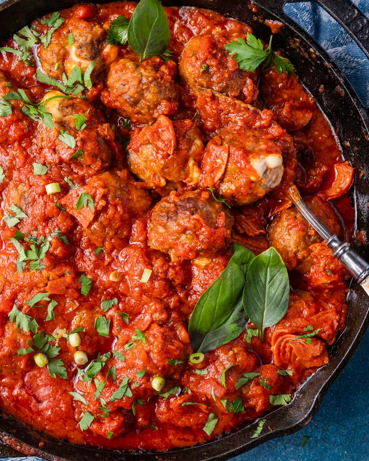 overhead view of meatballs in spaghetti sauce