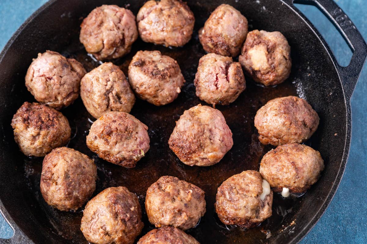 frying meatballs in a cast iron skillet