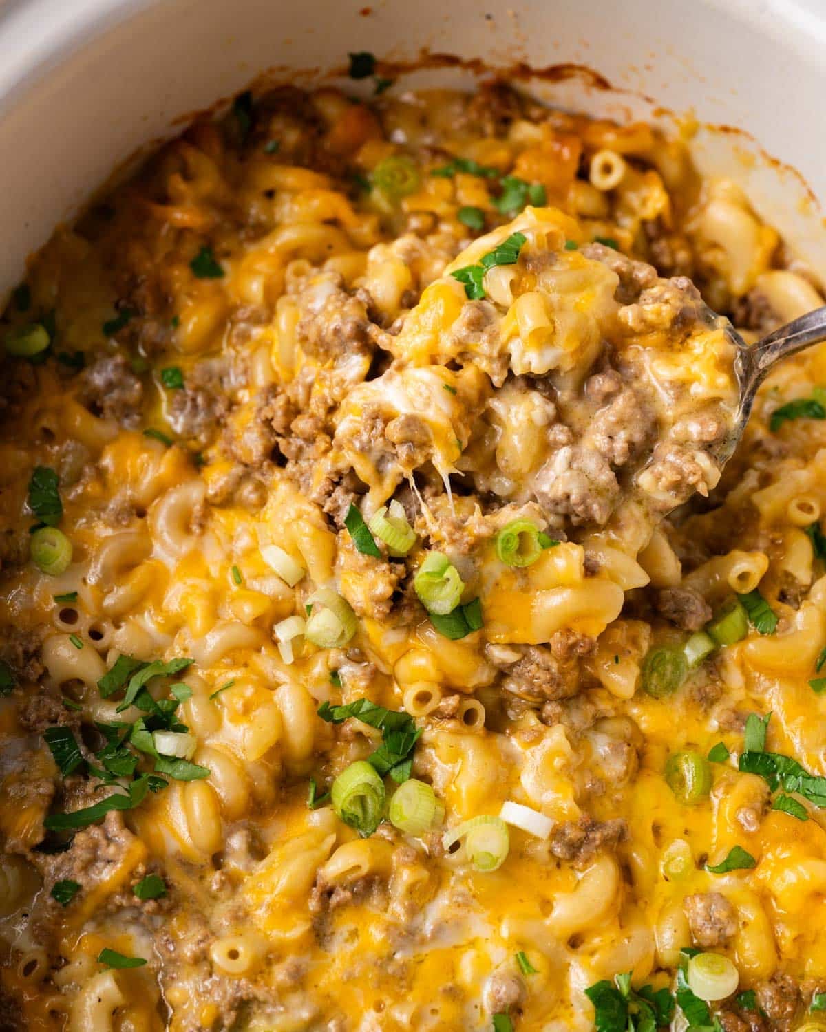 closeup of cheesy hamburger pasta in a slow cooker
