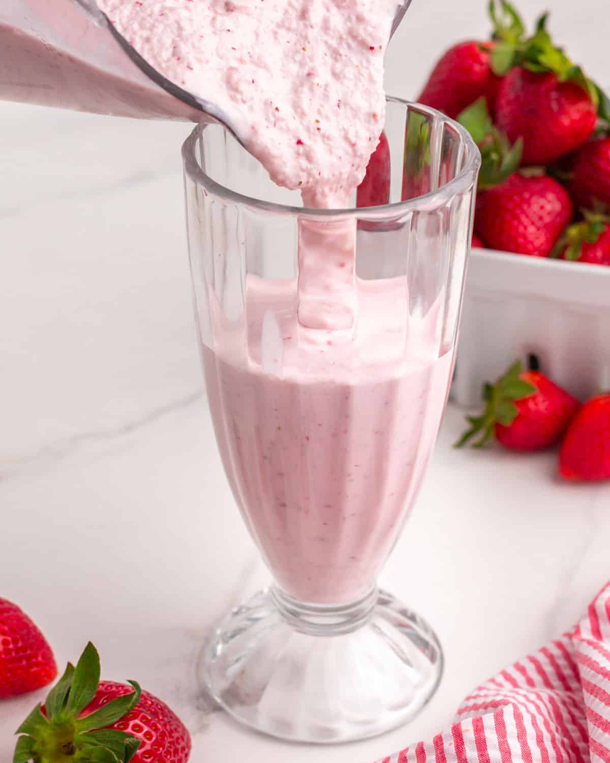 milkshake mixture pouring into a glass