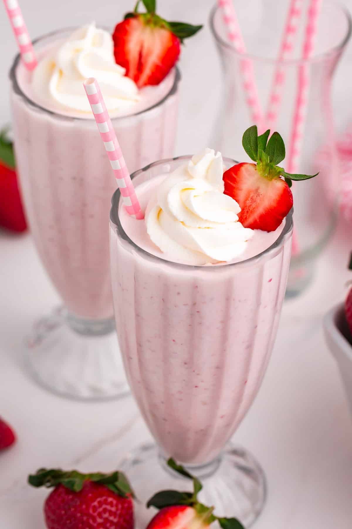 overhead view of two strawberry milkshakes