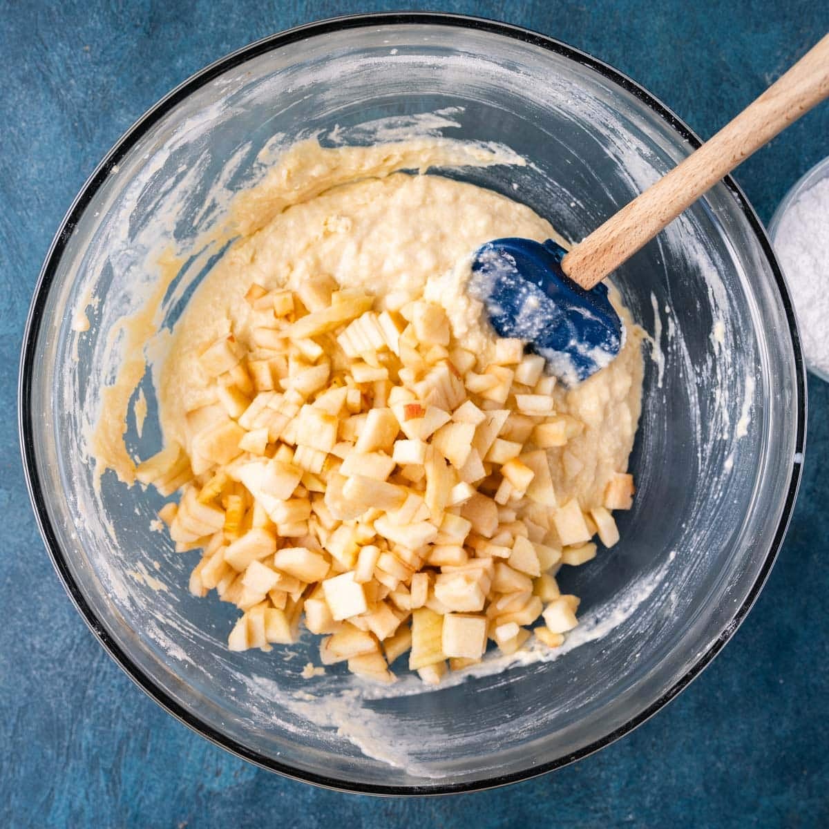 quick bread batter with diced apples on top in a bowl