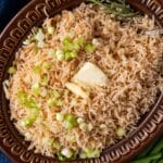 closeup of stick of butter rice in a bowl
