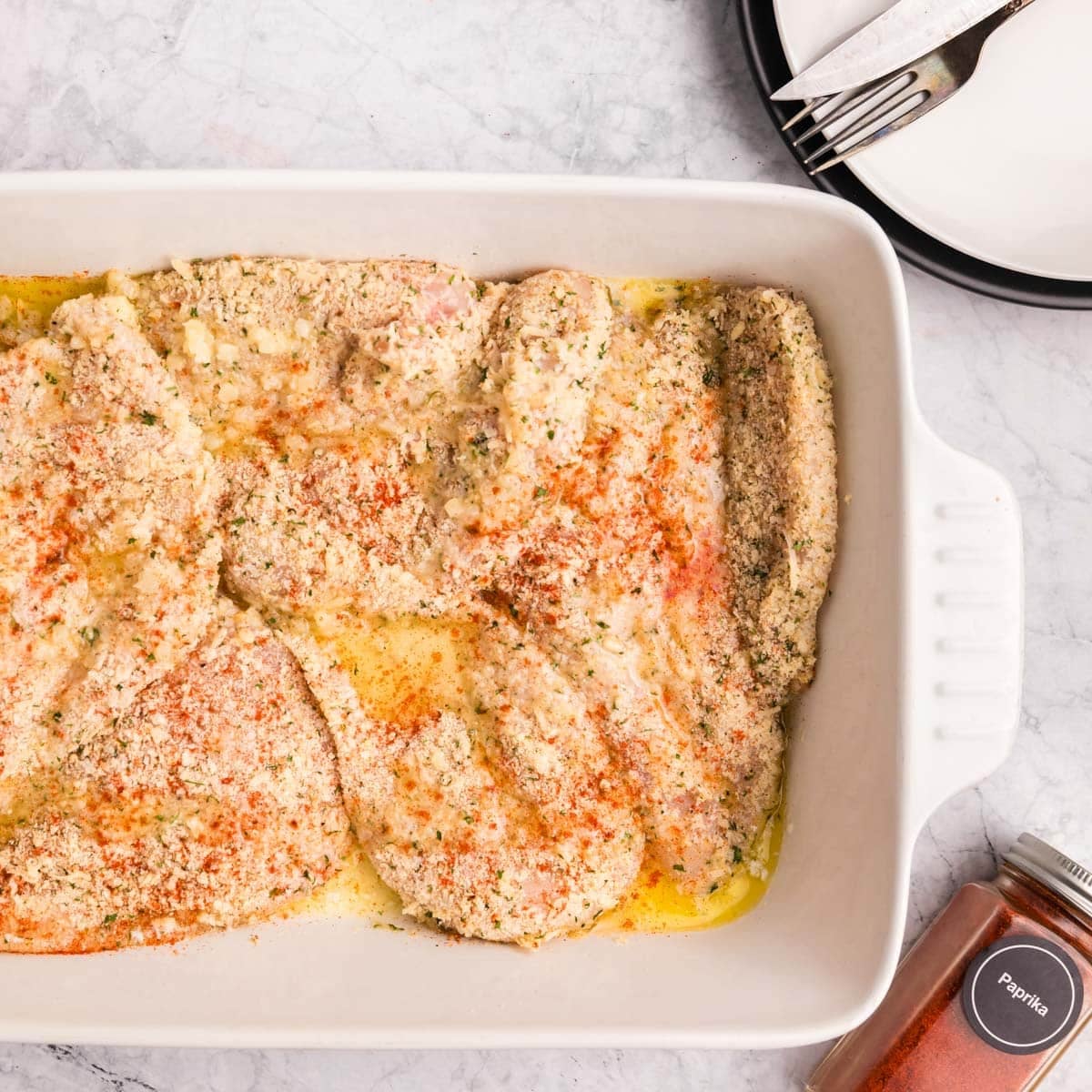 unbaked chicken in a casserole dish