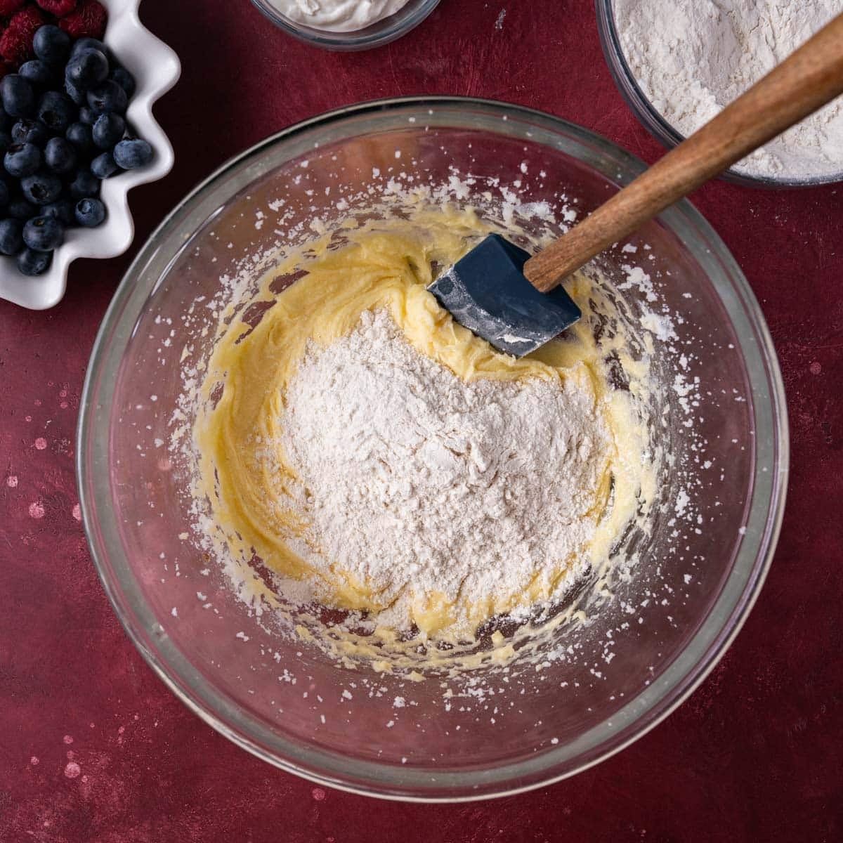 creamed butter and sugar with flour on top in a bowl