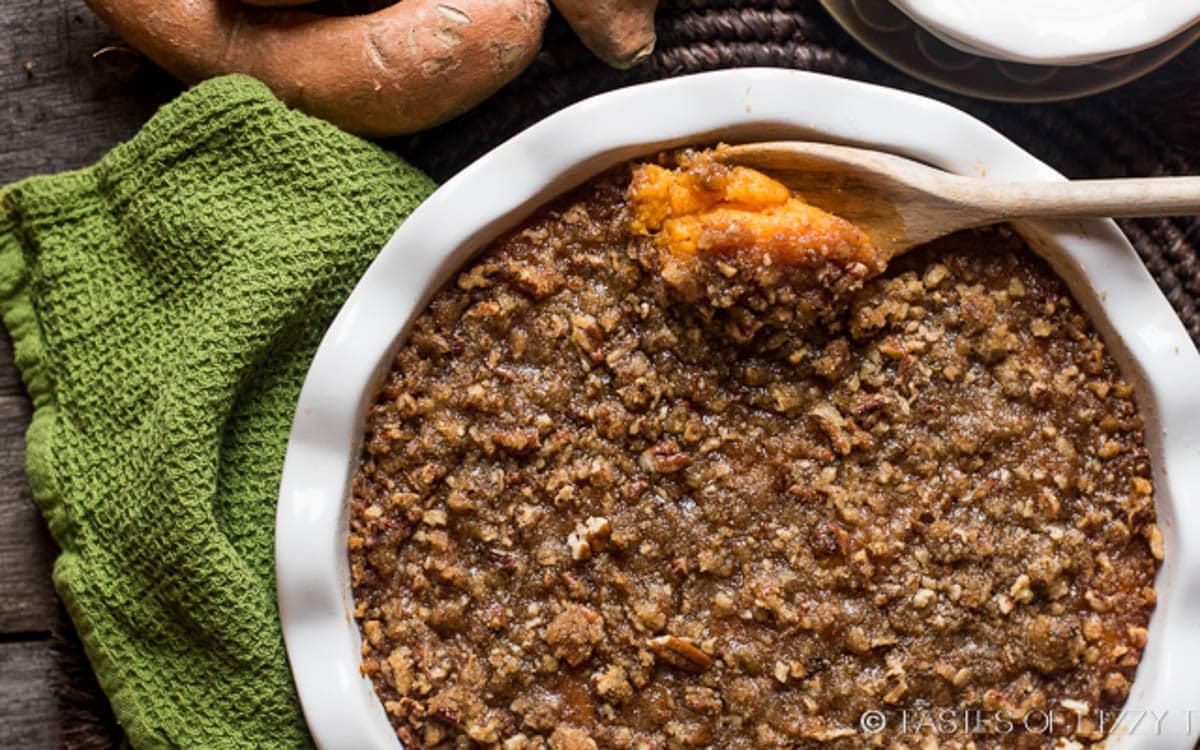 sweet potato casserole with a wooden spoon in it