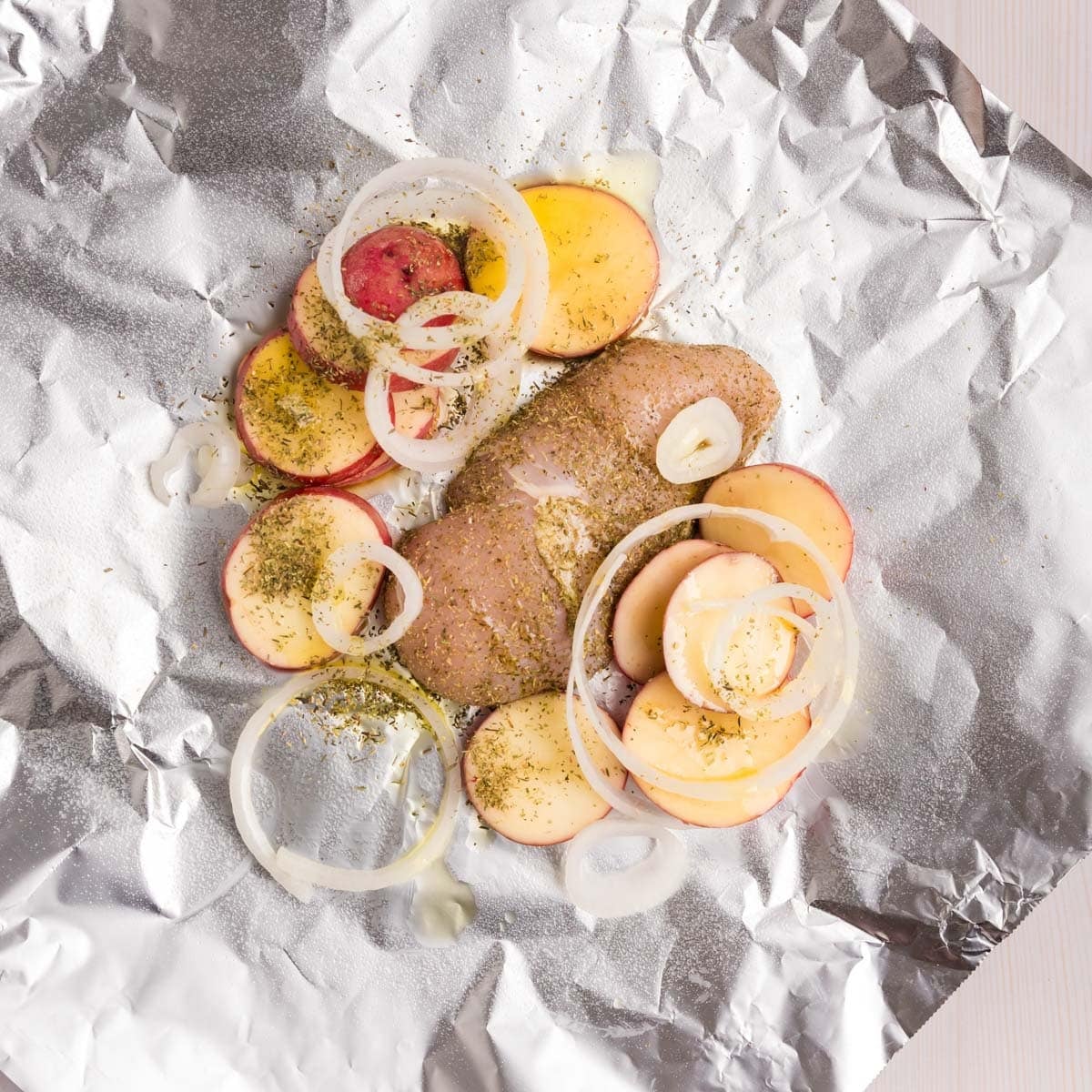 ingredients for chicken potato foil packets on a table