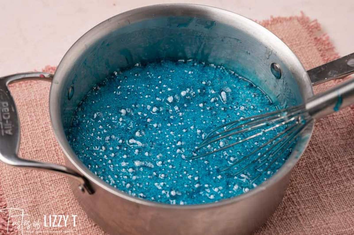 blue sugar water boiling in a pan