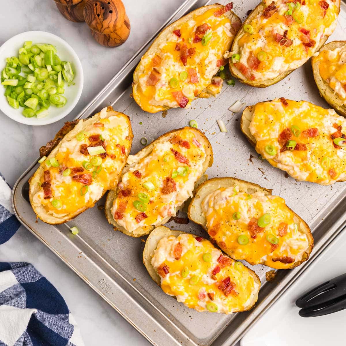 baked loaded potato halves on a baking sheet