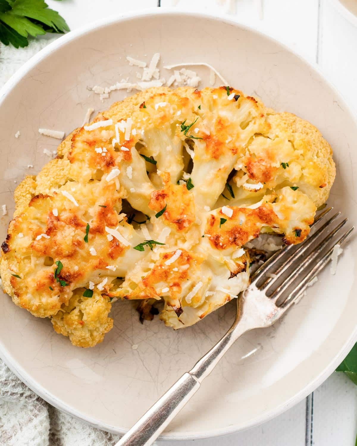 a baked cauliflower steak on a plate