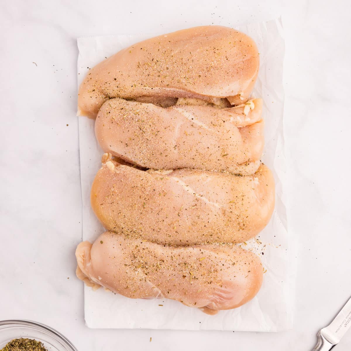seasoned chicken breasts on a counter