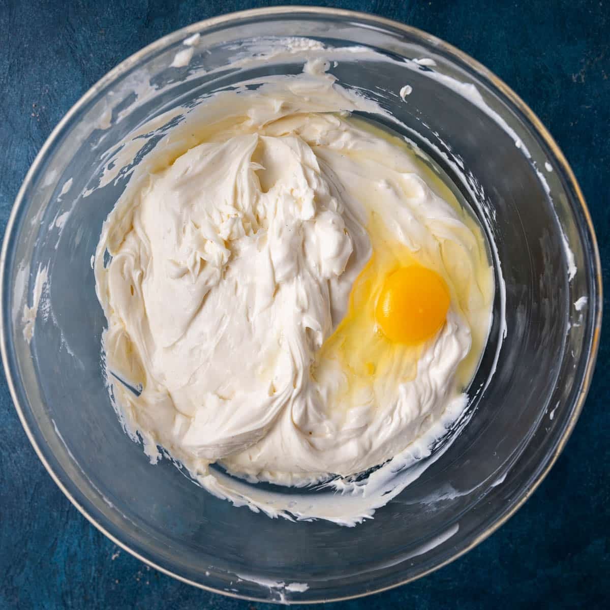 cheesecake batter with an uncooked egg on top