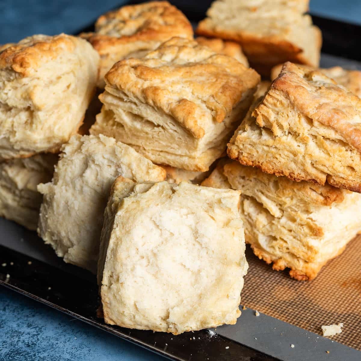 flaky biscuits, one cut in half, on a table