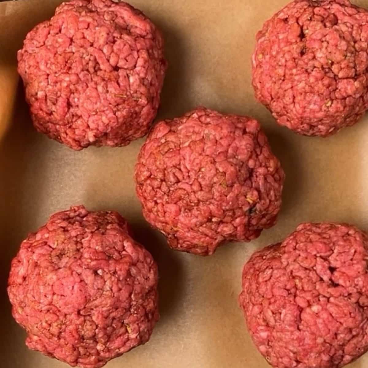 burger patties on parchment paper