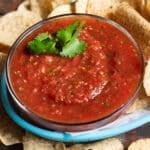 a bowl of blender salsa with chips