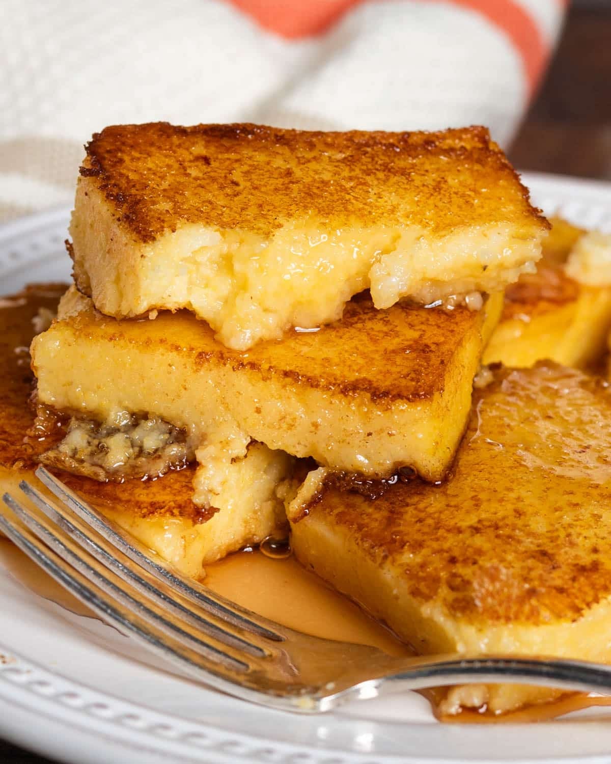 a stack of fried mush with syrup