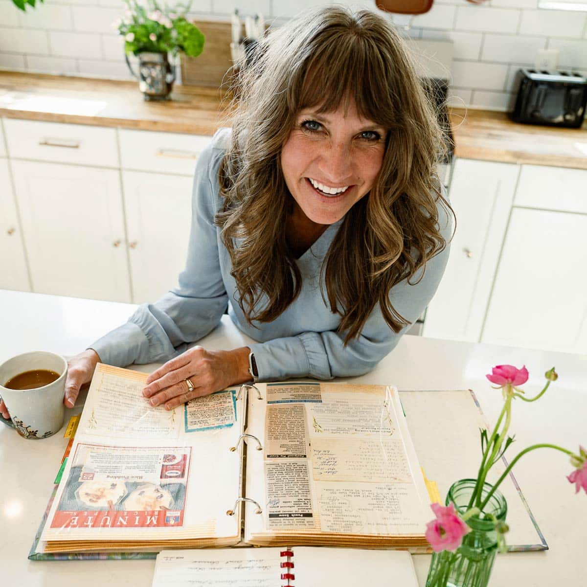 julie clark in a kitchen with a recipe book