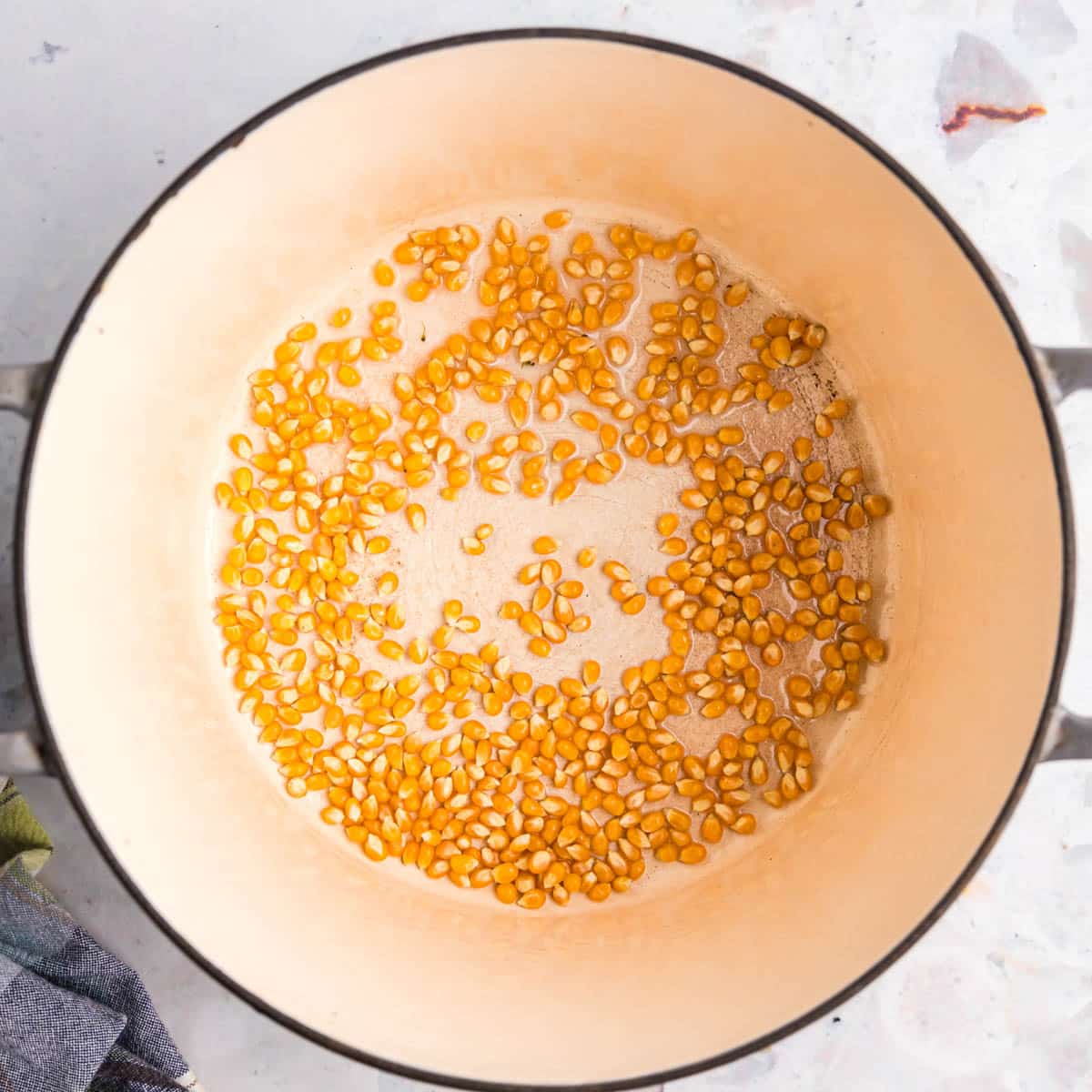 popcorn kernels and oil in a skillet