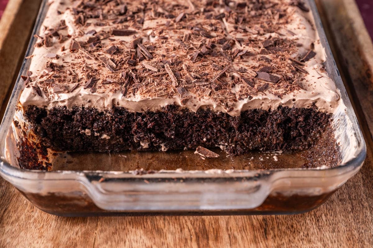 inside a chocolate tres leches cake in a pan