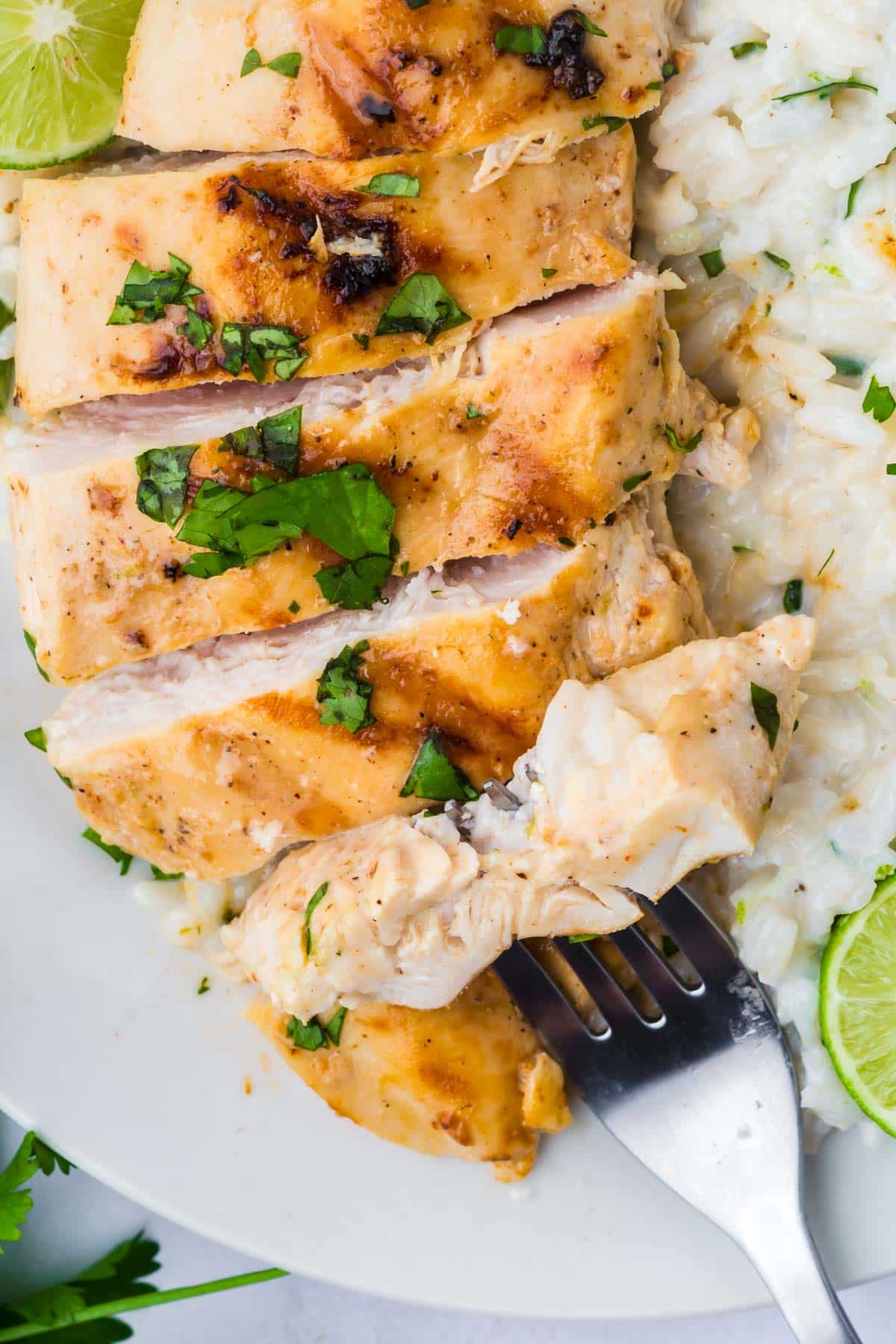closeup of a sliced chicken breast with a fork