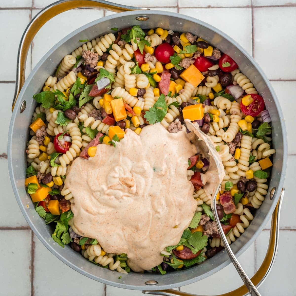 dressing over cowboy pasta salad in a saucepan