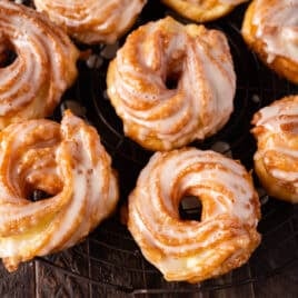 closeup of cruller donuts on a wire rack