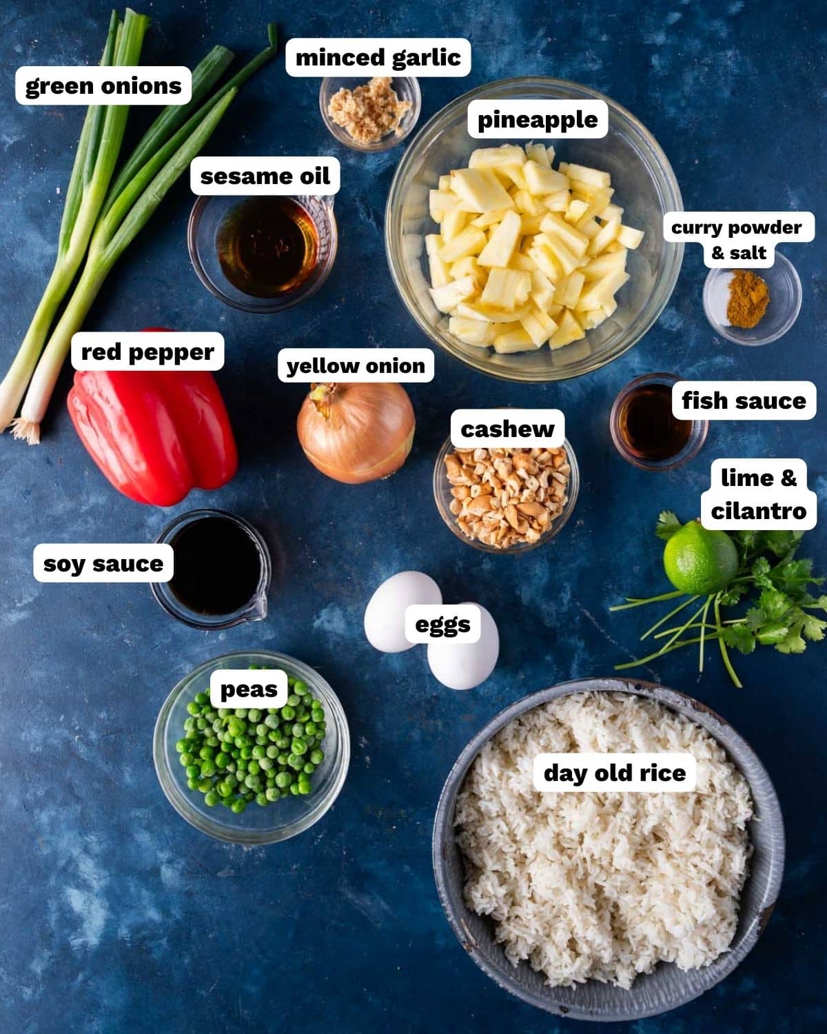 ingredients for fried rice with pineapple on a table