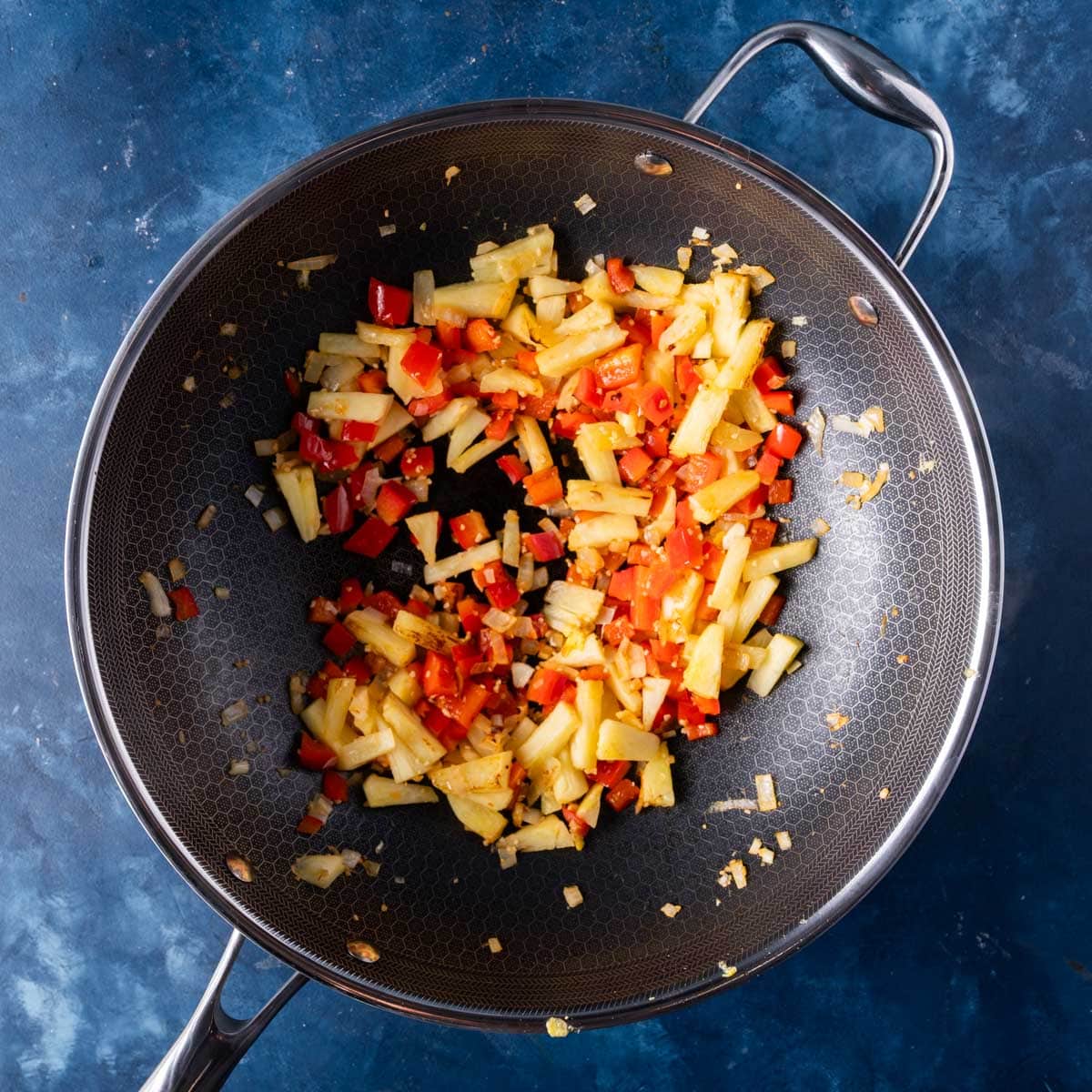 sauteed peppers and pineapple in a skillet