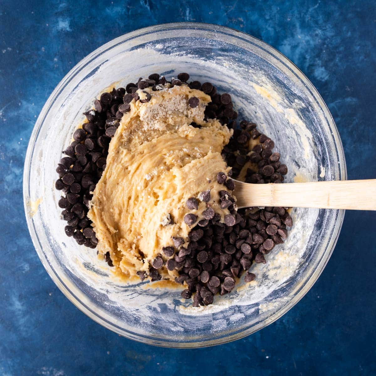 folding chocolate chips into cookie dough batter