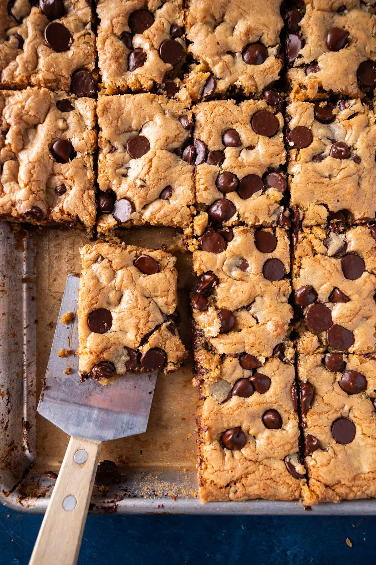 overhead view of sheet pan cookies with a cookie spatula