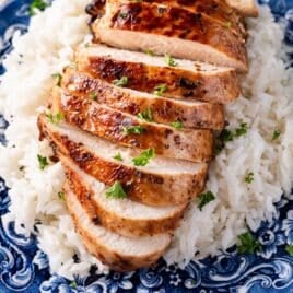 a sliced marinated chicken breast on a bed of rice