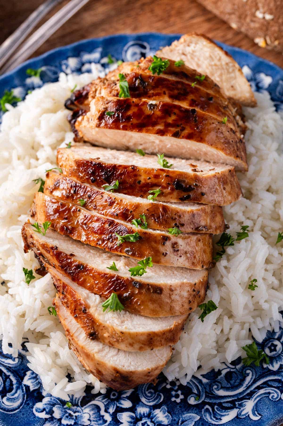 a sliced marinated chicken breast on a bed of rice