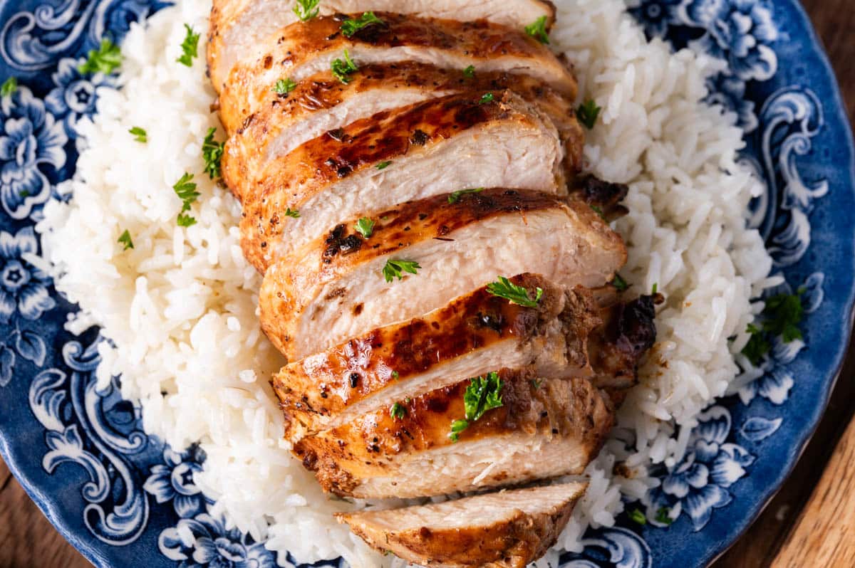 a sliced chicken breast on a bed of rice