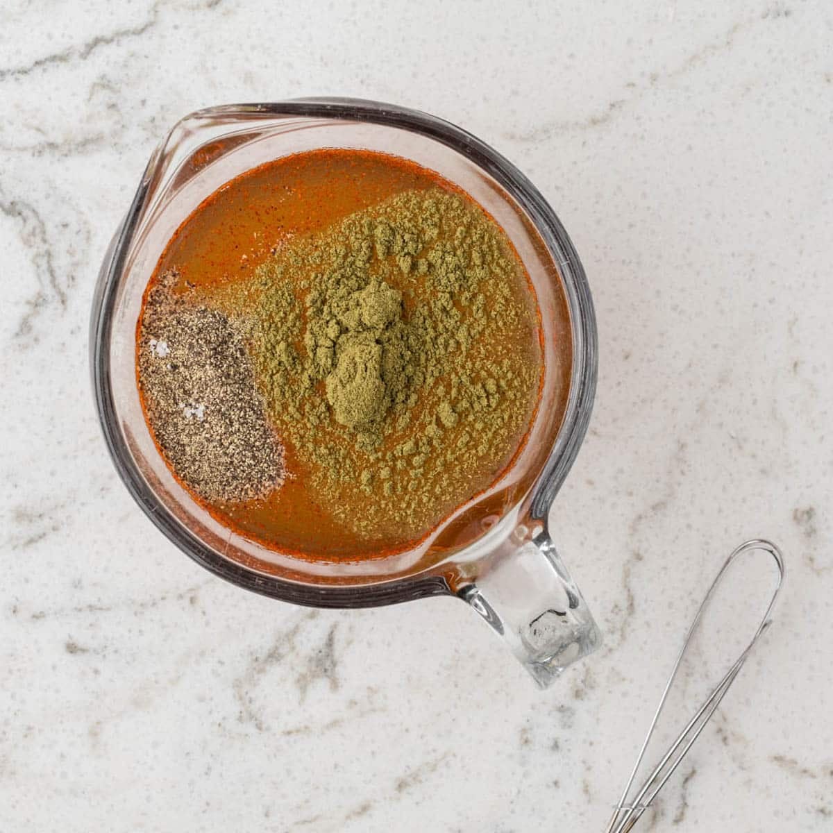 sauce for ham and beans in a measuring cup