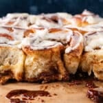 frosted sourdough discard cinnamon rolls on a table