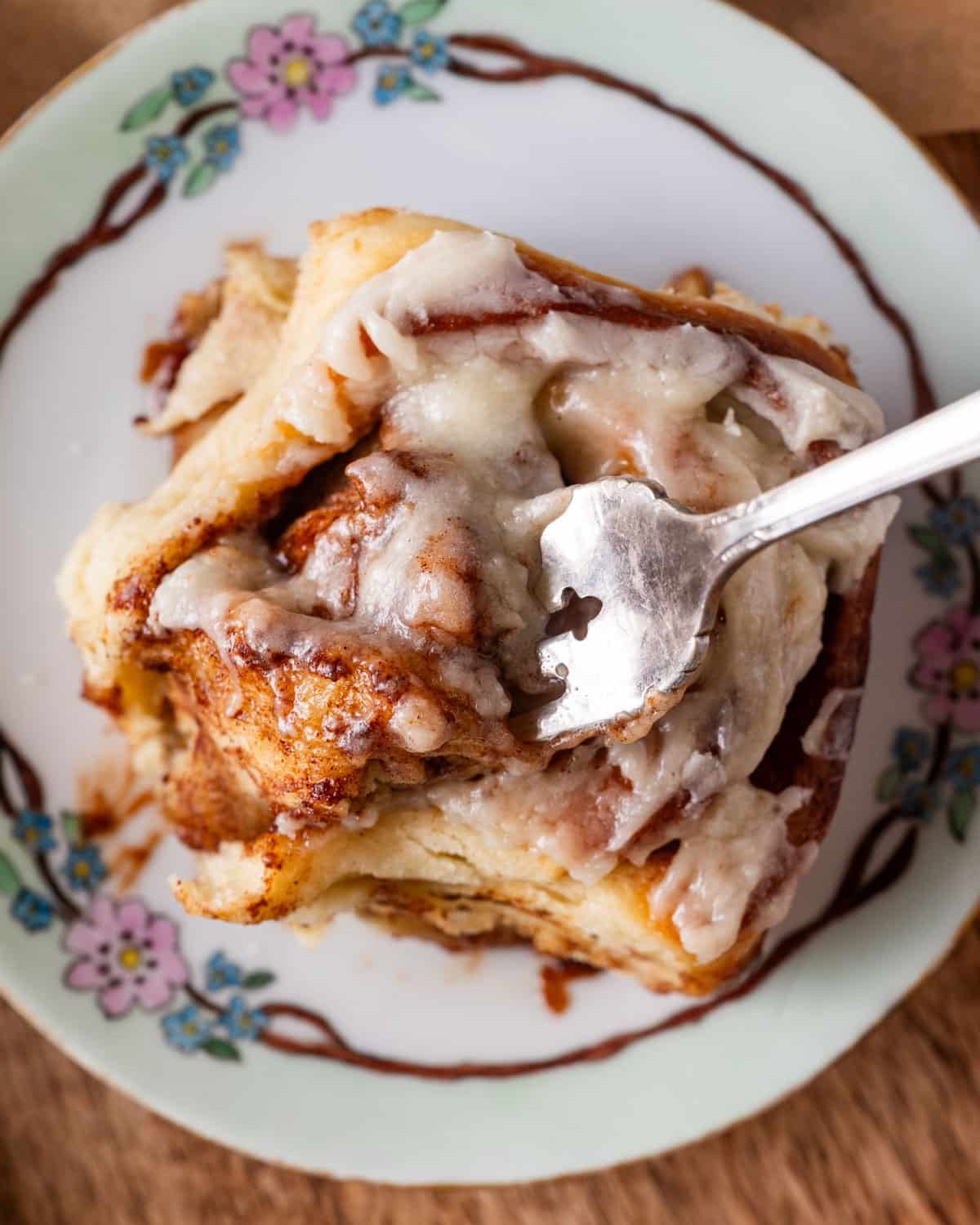 overhead view of a gooey cinnamon roll on a plate
