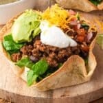 a taco salad bowl in a flour tortilla on a table