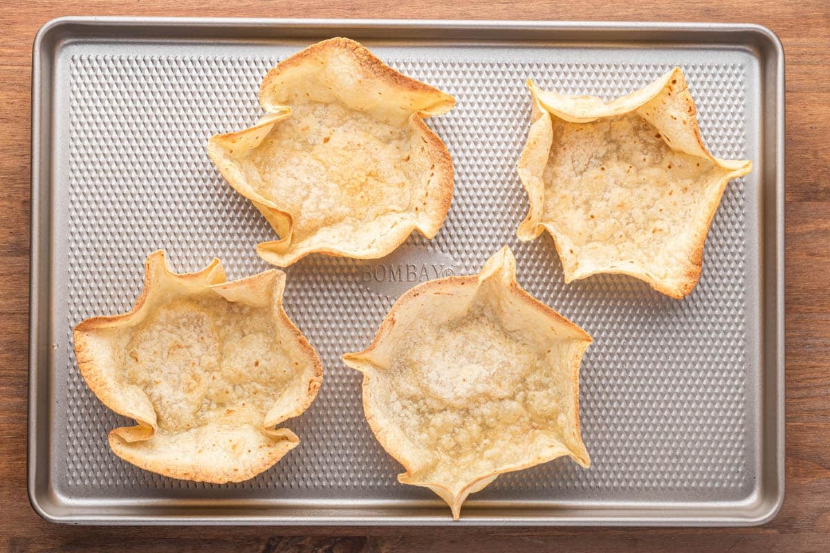 baked flour tortilla bowls on a baking sheet