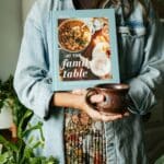 julie holding at the family table cookbook