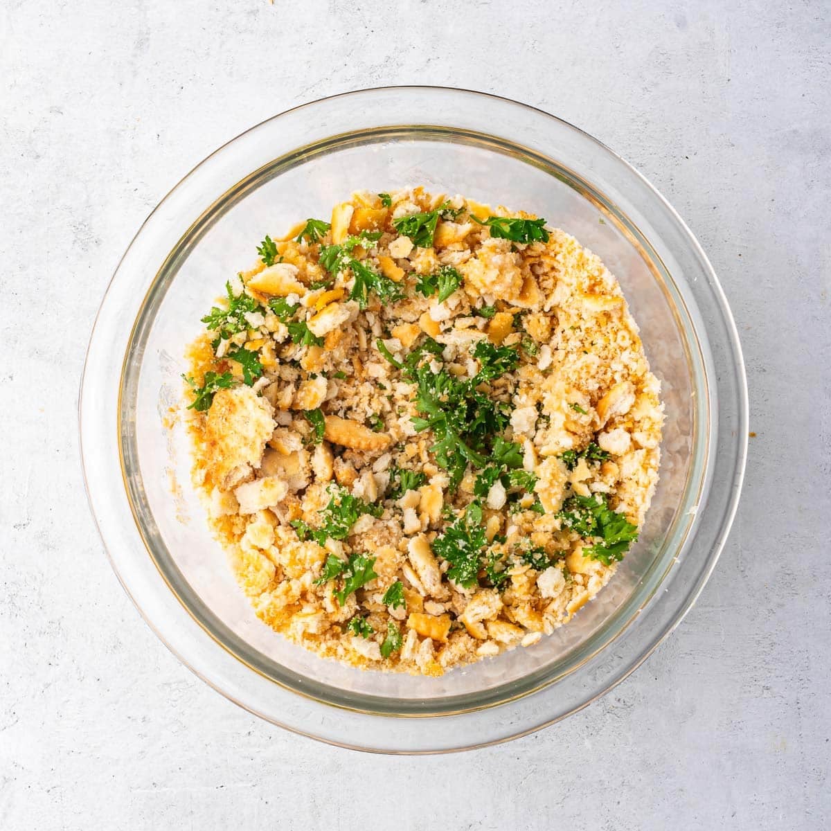 buttered ritz crackers in a bowl with fresh parsley