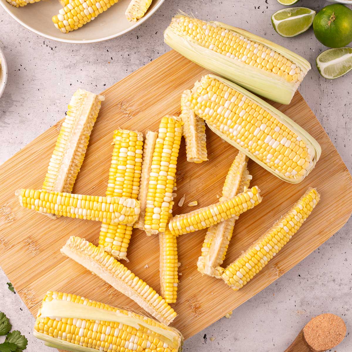whole corn cut in quarters on a cutting board