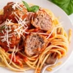 a plate of Italian meatballs on a plate with pasta and sauce